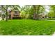 Spacious, lush green front lawn framing a charming brick home with mature trees, perfect for outdoor enjoyment at 5124 N Capitol Ave, Indianapolis, IN 46208