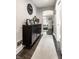 Entry hallway features a dark wood floor and decor, leading to a sunlit living space at 5124 N Capitol Ave, Indianapolis, IN 46208