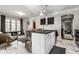 Open concept kitchen with island seating, white cabinetry, and marble floors, perfect for casual dining and meal prep at 5124 N Capitol Ave, Indianapolis, IN 46208
