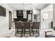 Modern kitchen with island, stainless steel appliances, and stylish bar stools, ideal for cooking and entertaining at 5124 N Capitol Ave, Indianapolis, IN 46208