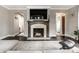 Cozy living room featuring a fireplace, hardwood floors, and lots of natural light at 5124 N Capitol Ave, Indianapolis, IN 46208