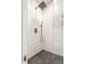 Modern shower with white tile, matte fixtures, and a mosaic tile floor at 5124 N Capitol Ave, Indianapolis, IN 46208
