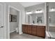 This bathroom offers double sinks, a large mirror, and neutral decor, providing a clean and functional space at 5163 Nettleton Way, Avon, IN 46123