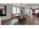 Bright dining room with hardwood floors and modern lighting fixture at 5163 Nettleton Way, Avon, IN 46123