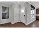 Elegant entryway with wood floors, white trim and contrasting wall paint at 5163 Nettleton Way, Avon, IN 46123