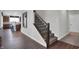 Bright foyer with a staircase and hardwood floors leads to an open-concept kitchen and living area, perfect for modern living at 5163 Nettleton Way, Avon, IN 46123