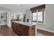 Open concept kitchen with barstool seating and view to living area at 5163 Nettleton Way, Avon, IN 46123