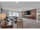 Comfortable living room with a large sectional sofa, modern entertainment center, and tasteful decor at 5163 Nettleton Way, Avon, IN 46123