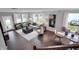 Open-concept living room with large windows and modern decor offers a welcoming and stylish space for relaxation and entertaining at 5163 Nettleton Way, Avon, IN 46123