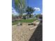 Landscaped backyard featuring a decorative rock garden, mature trees and playground equipment at 5218 Fletcher St, Anderson, IN 46013