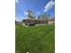 Beautiful backyard featuring a hot tub, lush green lawn, and a concrete patio with outdoor seating at 5218 Fletcher St, Anderson, IN 46013