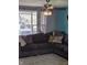 Comfortable living room featuring a large sectional couch, stylish lighting, and a large window at 5218 Fletcher St, Anderson, IN 46013