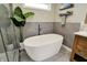 Bright bathroom features a standalone tub, modern tile, and a minimalist design at 5255 Apache Moon, Carmel, IN 46033