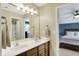 Bathroom featuring a double sink vanity, tiled floor, and view to bedroom and shower at 5255 Apache Moon, Carmel, IN 46033