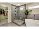 Modern bathroom featuring a tiled glass shower, soaking tub, and serene design at 5255 Apache Moon, Carmel, IN 46033