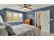 Bright bedroom with a ceiling fan, large window, and en suite bathroom access at 5255 Apache Moon, Carmel, IN 46033