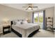 Inviting bedroom with a neutral color scheme, ceiling fan, and a large window with natural light at 5255 Apache Moon, Carmel, IN 46033