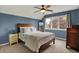 Cozy bedroom featuring a ceiling fan, large window, and a comfortable bed with stylish bedding at 5255 Apache Moon, Carmel, IN 46033