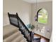 Grand foyer with dark wood staircase, arched window and door, and hardwood floors at 5255 Apache Moon, Carmel, IN 46033