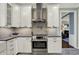 Bright kitchen featuring stainless steel stove with hood and subway tile backsplash at 5255 Apache Moon, Carmel, IN 46033