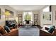 Cozy living room with hardwood floors, piano and bright natural light at 5255 Apache Moon, Carmel, IN 46033