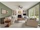 Bright living room with fireplace, built-in shelving, and large windows at 5255 Apache Moon, Carmel, IN 46033