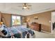 Comfortable bedroom featuring a ceiling fan, soft carpet, and a charming window view at 5255 Apache Moon, Carmel, IN 46033