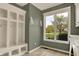 Bright mudroom boasts white cubbies for storage, towel rack, tile flooring and a view to the front yard at 5255 Apache Moon, Carmel, IN 46033