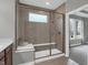 Large glass shower features a bench and window providing natural light at 5291 Nettleton Way, Avon, IN 46123