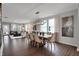 Open-concept dining room featuring wood floors, stylish lighting, and access to the living room at 5291 Nettleton Way, Avon, IN 46123