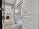 Hallway showcases sliding barn doors leading to a bathroom, blending functionality with style at 5291 Nettleton Way, Avon, IN 46123