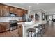 Stylish kitchen with stainless steel appliances, granite counters, and dark wood cabinets at 5291 Nettleton Way, Avon, IN 46123