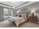 Serene main bedroom features tray ceiling, plush bedding, and lots of natural light from the window at 5291 Nettleton Way, Avon, IN 46123