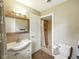 Bathroom featuring a tiled shower, vanity with sink, and modern lighting at 5305 N Cork Dr, Muncie, IN 47304
