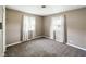 Simple bedroom with neutral walls, carpet flooring, and bright windows at 5305 N Cork Dr, Muncie, IN 47304