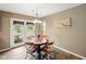 Cozy dining area features a round table, wood floors, and light fixture at 5305 N Cork Dr, Muncie, IN 47304
