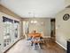 Inviting dining area with access to the outdoors and wood-look tile floors at 5305 N Cork Dr, Muncie, IN 47304