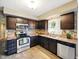 Modern kitchen featuring stainless steel appliances, tile backsplash, and wood-look floors at 5305 N Cork Dr, Muncie, IN 47304