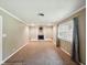 Cozy living room with a brick fireplace and a large window at 5305 N Cork Dr, Muncie, IN 47304