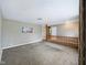 Open-concept living room with neutral carpet and railing at 5305 N Cork Dr, Muncie, IN 47304