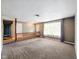 Spacious living room with neutral carpet and large window overlooking the front yard at 5305 N Cork Dr, Muncie, IN 47304