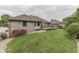Backyard featuring a well-maintained lawn, flower beds, and an elevated deck at 5499 Steven Dr, Greenwood, IN 46142