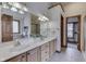 Bathroom featuring double sinks and a doorway that leads to the walk-in closet at 5499 Steven Dr, Greenwood, IN 46142