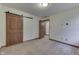 Neutral bedroom showcasing a sliding barn door and ensuite bathroom at 5499 Steven Dr, Greenwood, IN 46142