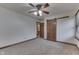 Neutral bedroom with carpet floors, a ceiling fan, and closet doors at 5499 Steven Dr, Greenwood, IN 46142