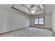 Bright bedroom featuring a decorative tray ceiling and a sunlit window at 5499 Steven Dr, Greenwood, IN 46142