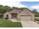 Charming brick home featuring an attached garage, well-manicured lawn, and a welcoming front entrance at 5499 Steven Dr, Greenwood, IN 46142