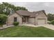 Beautiful brick home with an attached garage, an American flag, and lush green lawn at 5499 Steven Dr, Greenwood, IN 46142