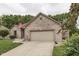 Brick home featuring an attached garage, well-maintained lawn, and traditional design elements at 5499 Steven Dr, Greenwood, IN 46142