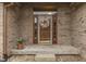 Inviting front entrance adorned with a decorative wreath and potted flowers, enhancing curb appeal at 5499 Steven Dr, Greenwood, IN 46142